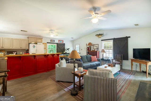 a living room with furniture and a flat screen tv
