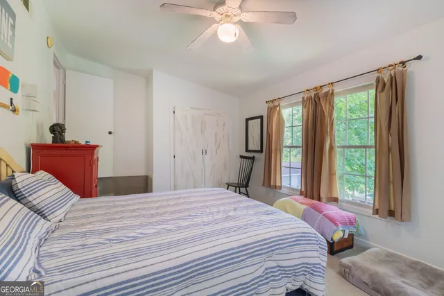 a bedroom with a large bed and a window