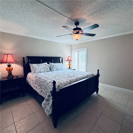 a living room with a bed and a chandelier