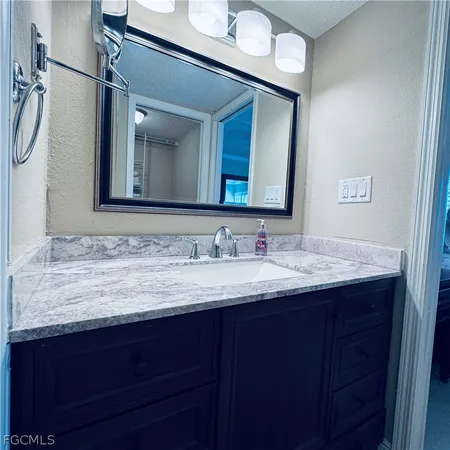 a bathroom with a glass shower door