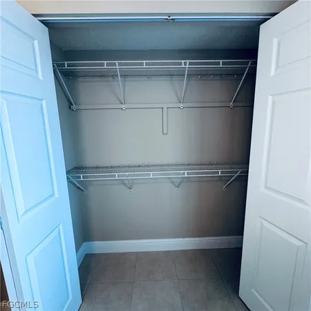 a bathroom with a granite countertop bathtub sink vanity mirror and toilet