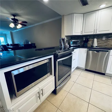 a kitchen with stainless steel appliances a stove a microwave and cabinets