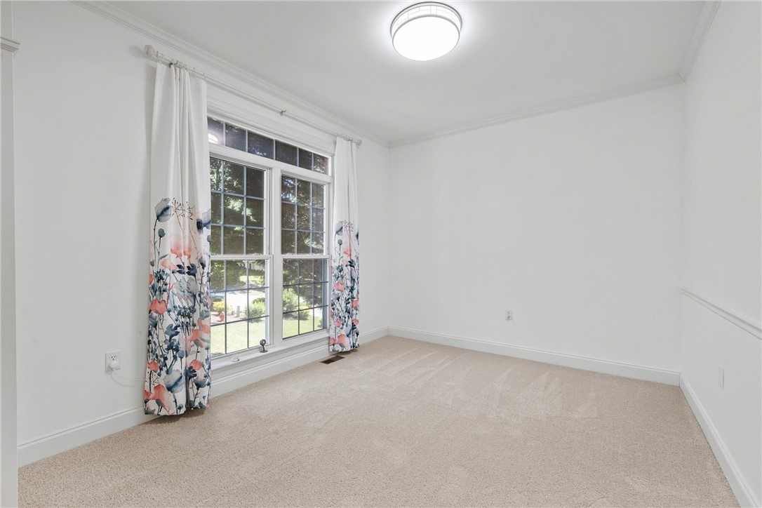 110 Brookstone Way Central, SC 29630 - Photo 6 of 46 Bright and airy room with large windows, plush carpeting, and elegant crown molding.