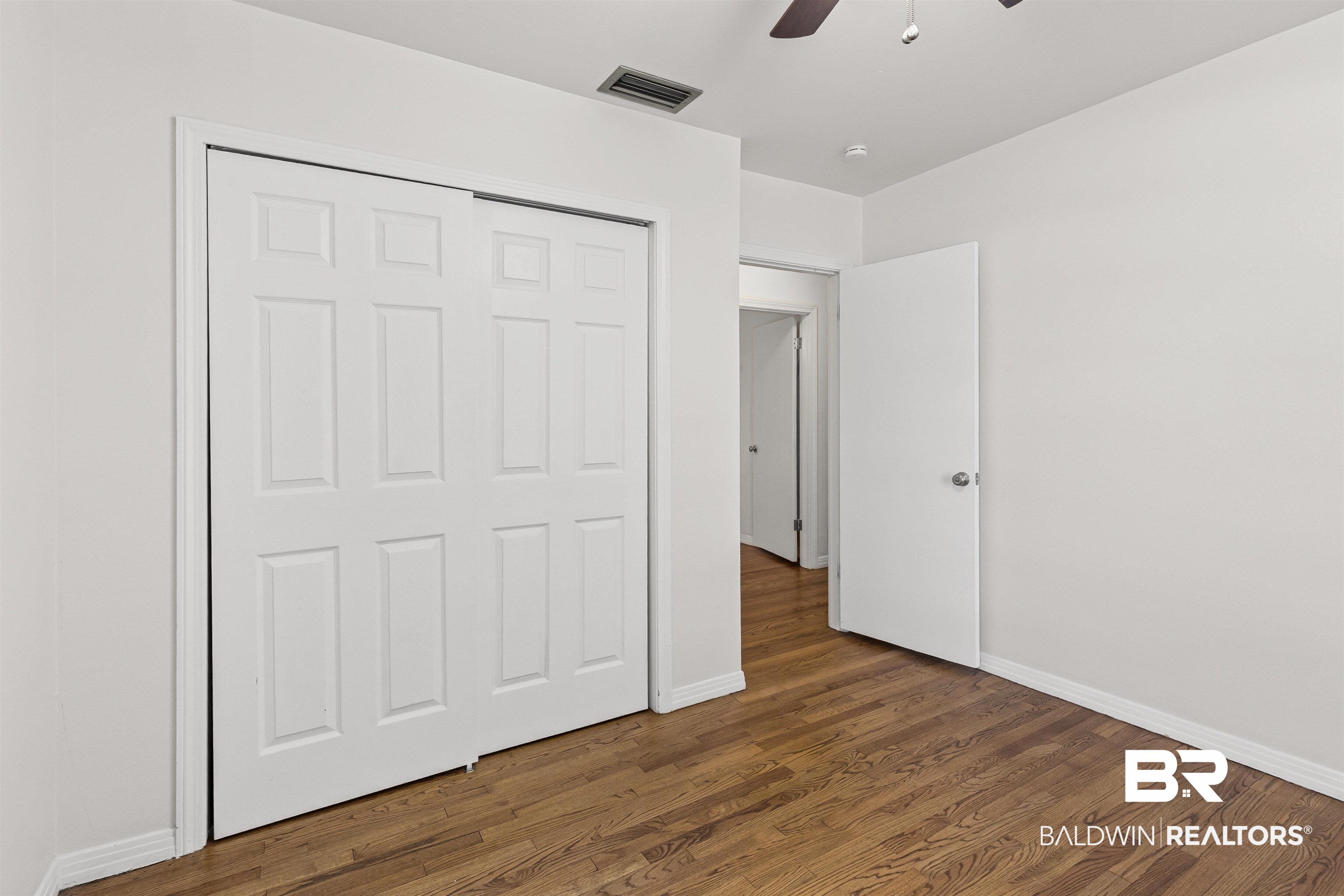1108 Locarno Street Mobile, AL 36608 - Photo 16 of 24 Unfurnished bedroom featuring wood finished floors, a ceiling fan, and a closet