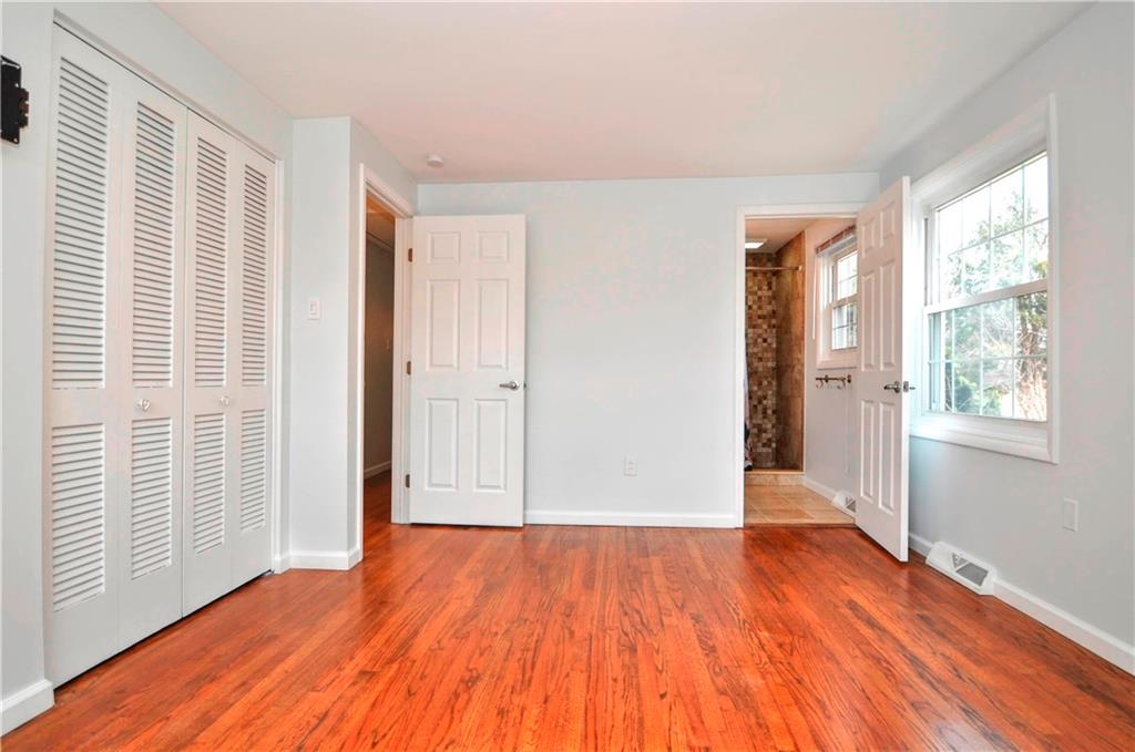 1313 Star Ridge Drive Pittsburgh, PA 15241 - Photo 20 of 36 an empty room with wooden floor and windows