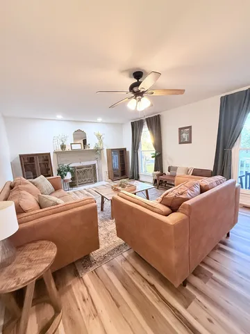 a living room with furniture and a chandelier