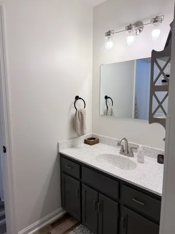 a bathroom with a sink and a mirror