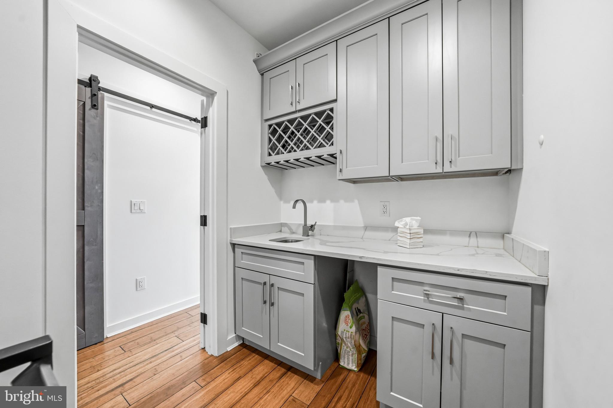 2604 Reed Street Philadelphia, PA 19146 - Photo 24 of 45 a kitchen with a sink cabinets and wooden floor