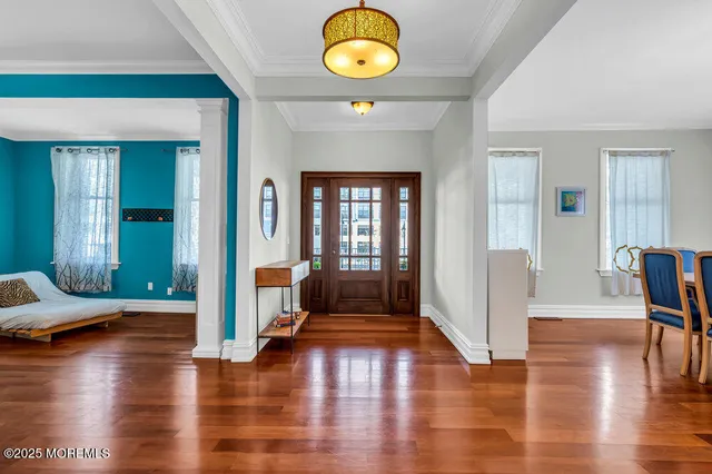 a view of an entryway with wooden floor and windows