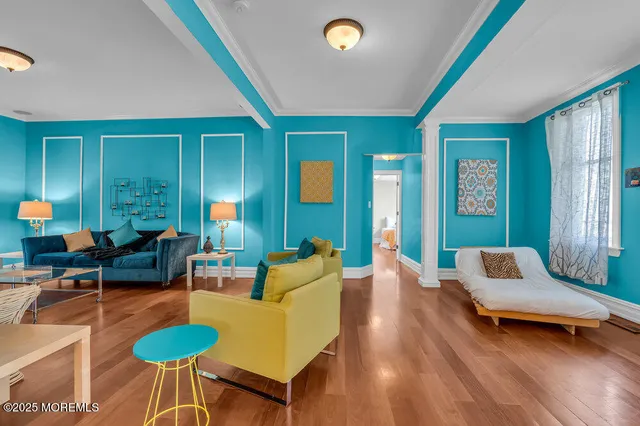 a living room with furniture and wooden floor