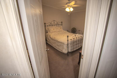 7169 Gas Line Road Keystone Heights, FL 32656 - Photo 20 of 31 a bedroom with a bed and a mirror