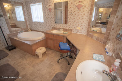 7169 Gas Line Road Keystone Heights, FL 32656 - Photo 28 of 31 a bathroom with a tub sink and mirror