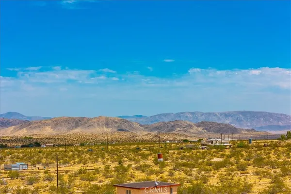 a view of an ocean beach and mountain