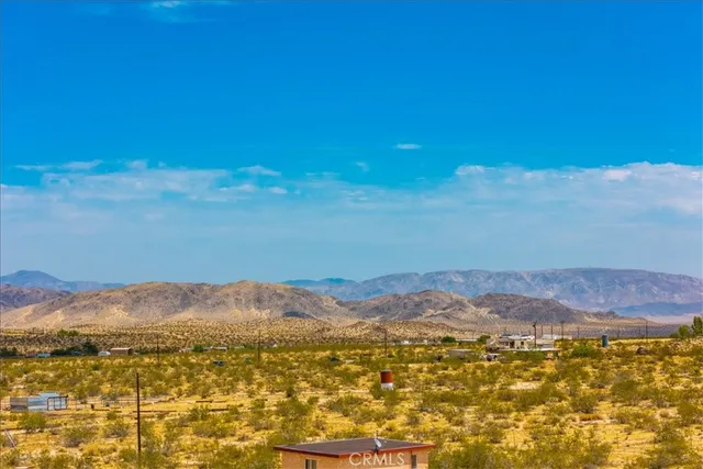 a view of an ocean beach and mountain