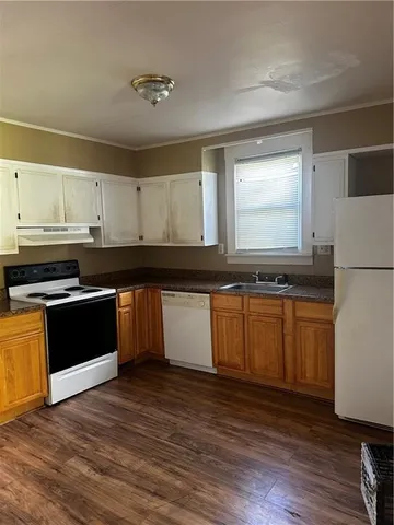 a kitchen with granite countertop a refrigerator and a stove