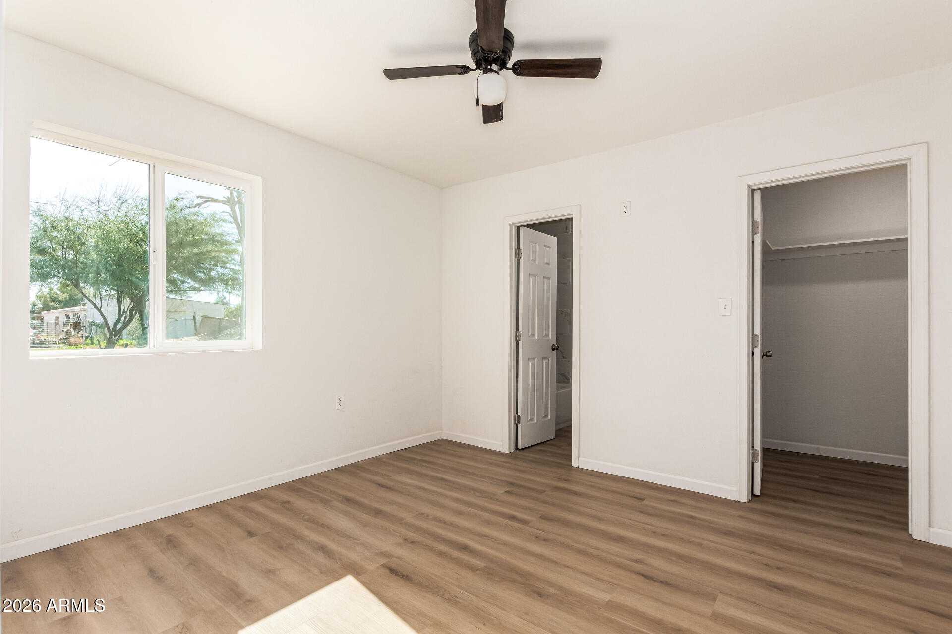 411 West Bealey Avenue Coolidge, AZ 85128 - Photo 11 of 26 a view of an empty room with wooden floor and a window