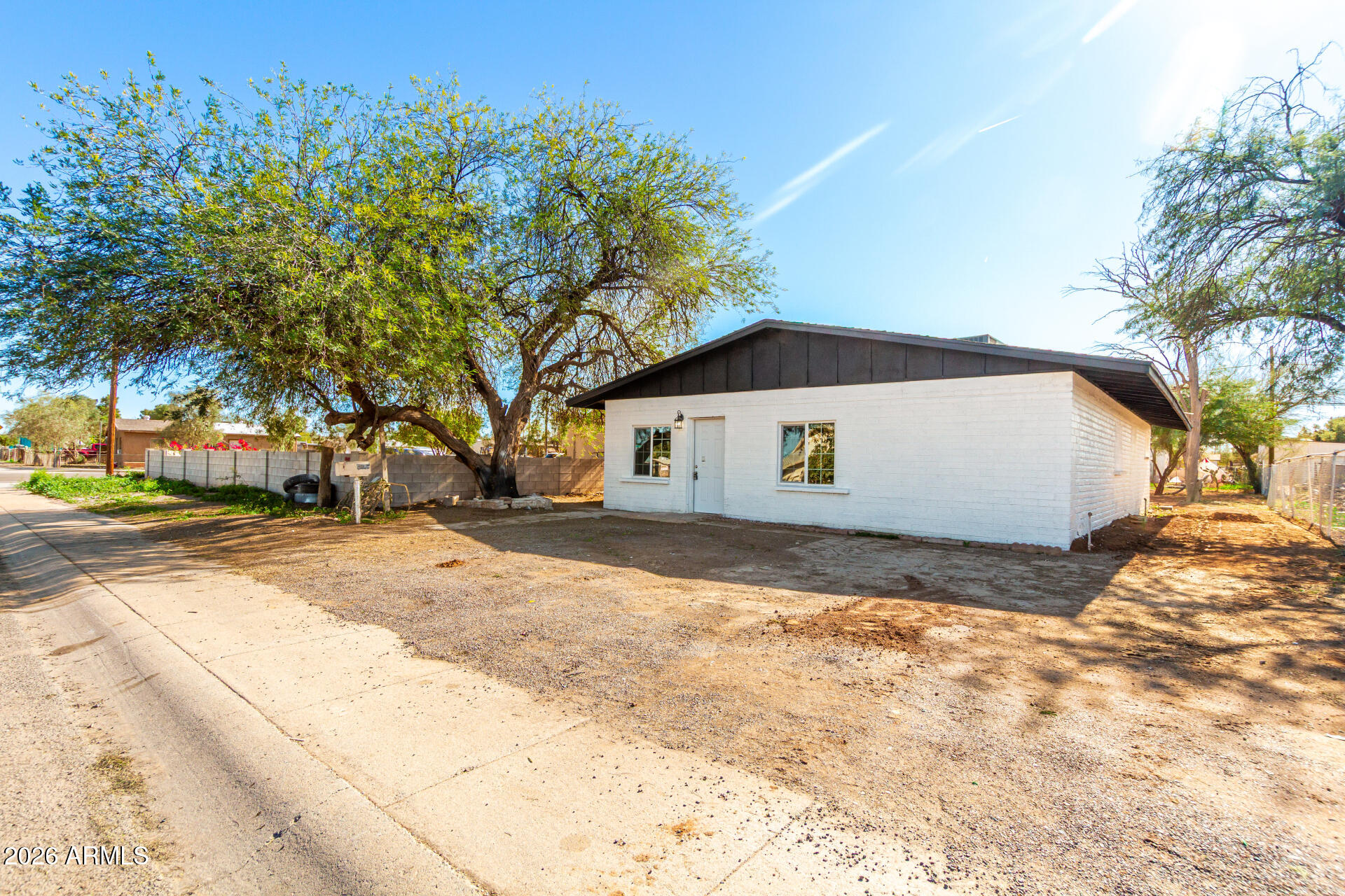 411 West Bealey Avenue Coolidge, AZ 85128 - Photo 26 of 26 a front view of a house with a yard and garage
