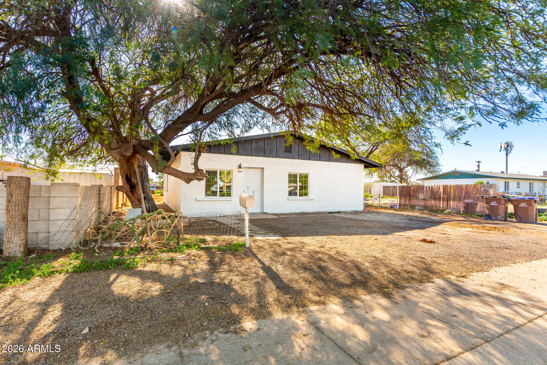 411 West Bealey Avenue Coolidge, AZ 85128 - Photo 3 of 26 a front view of a house with a yard and garage