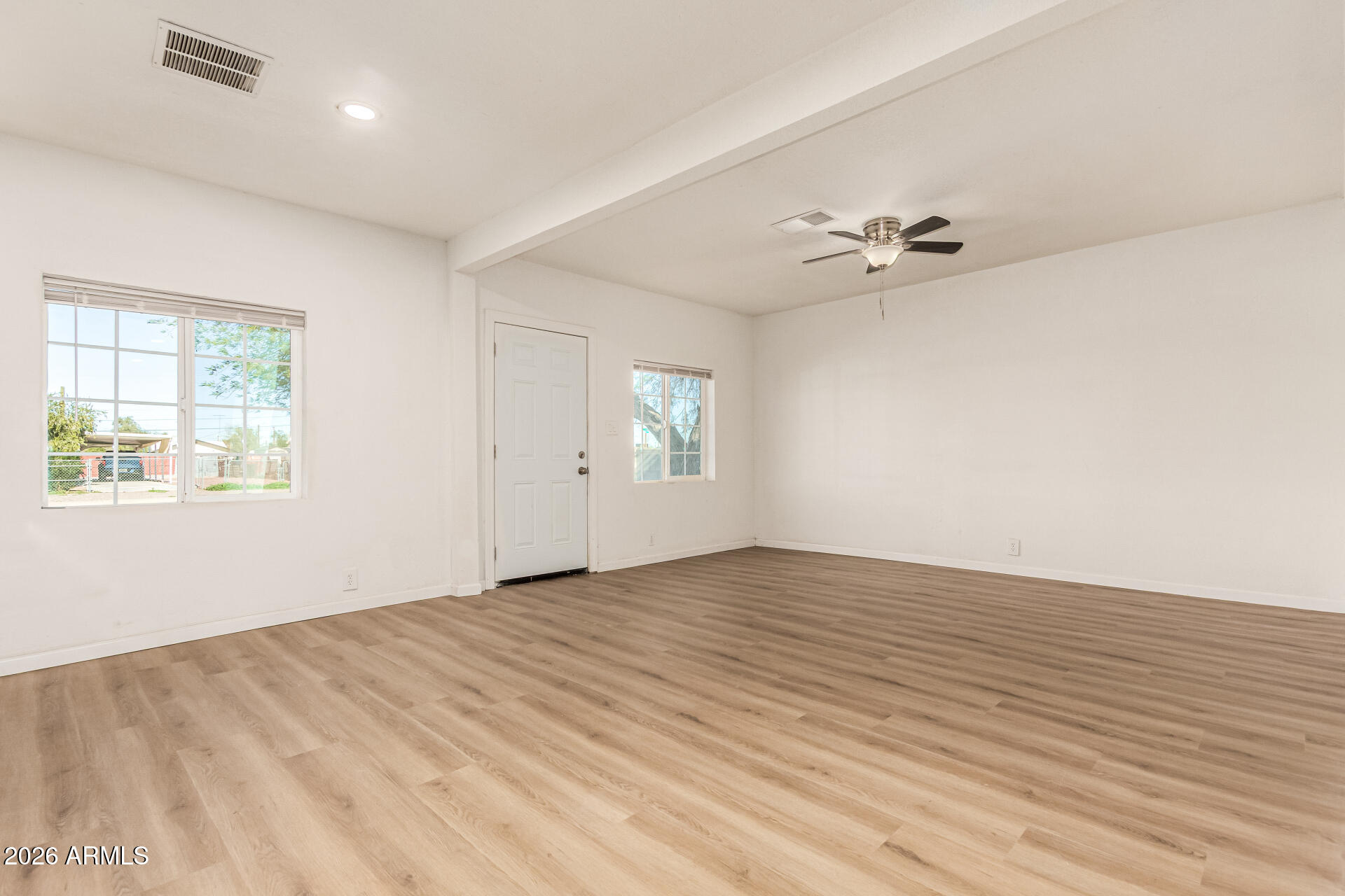 411 West Bealey Avenue Coolidge, AZ 85128 - Photo 4 of 26 wooden floor in an empty room with a window