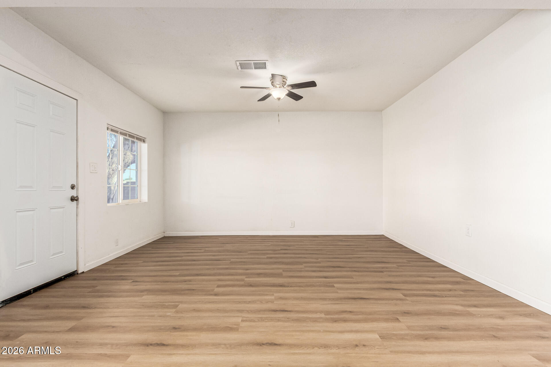 411 West Bealey Avenue Coolidge, AZ 85128 - Photo 5 of 26 wooden floor in an empty room