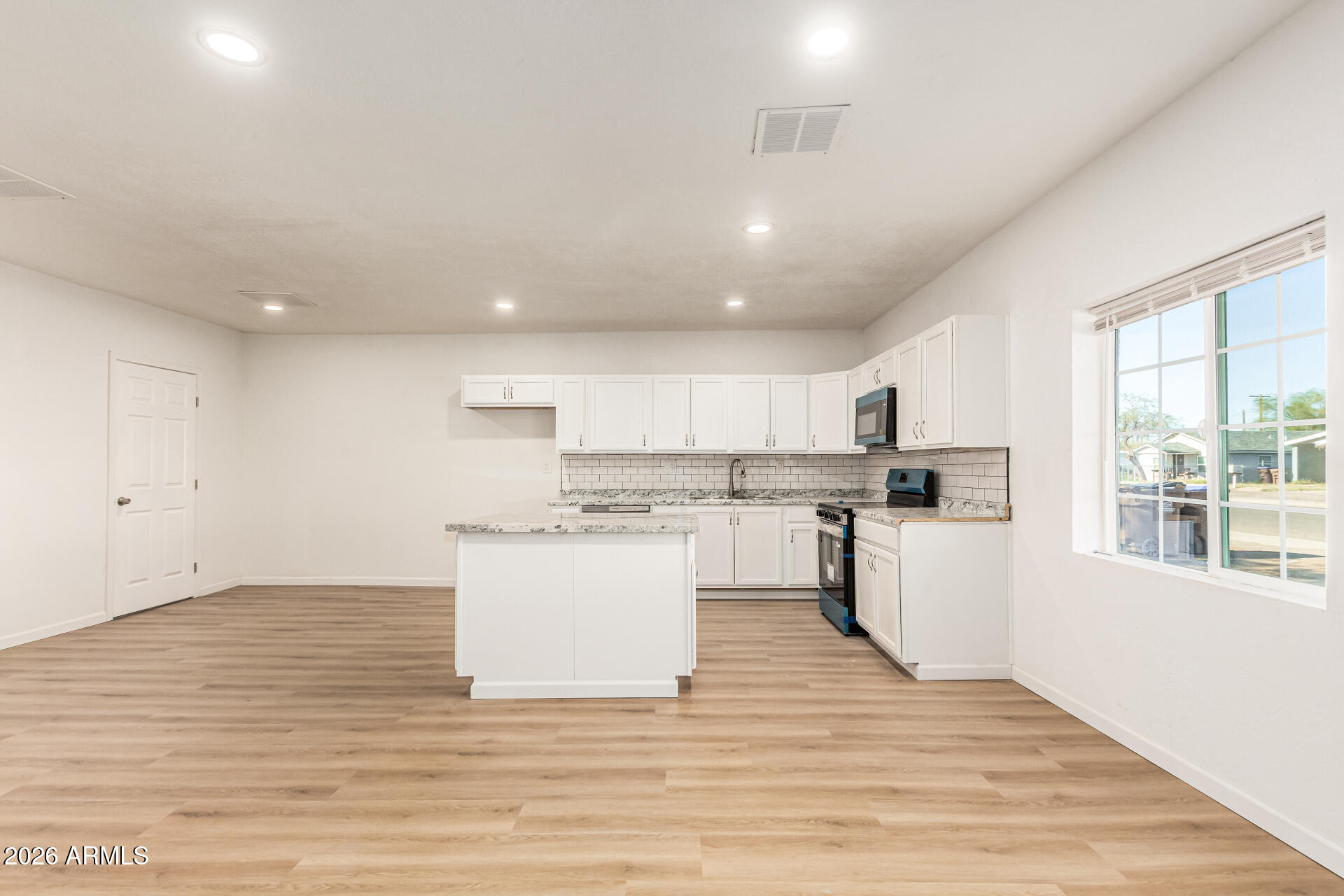 411 West Bealey Avenue Coolidge, AZ 85128 - Photo 7 of 26 a view of kitchen with wooden floor