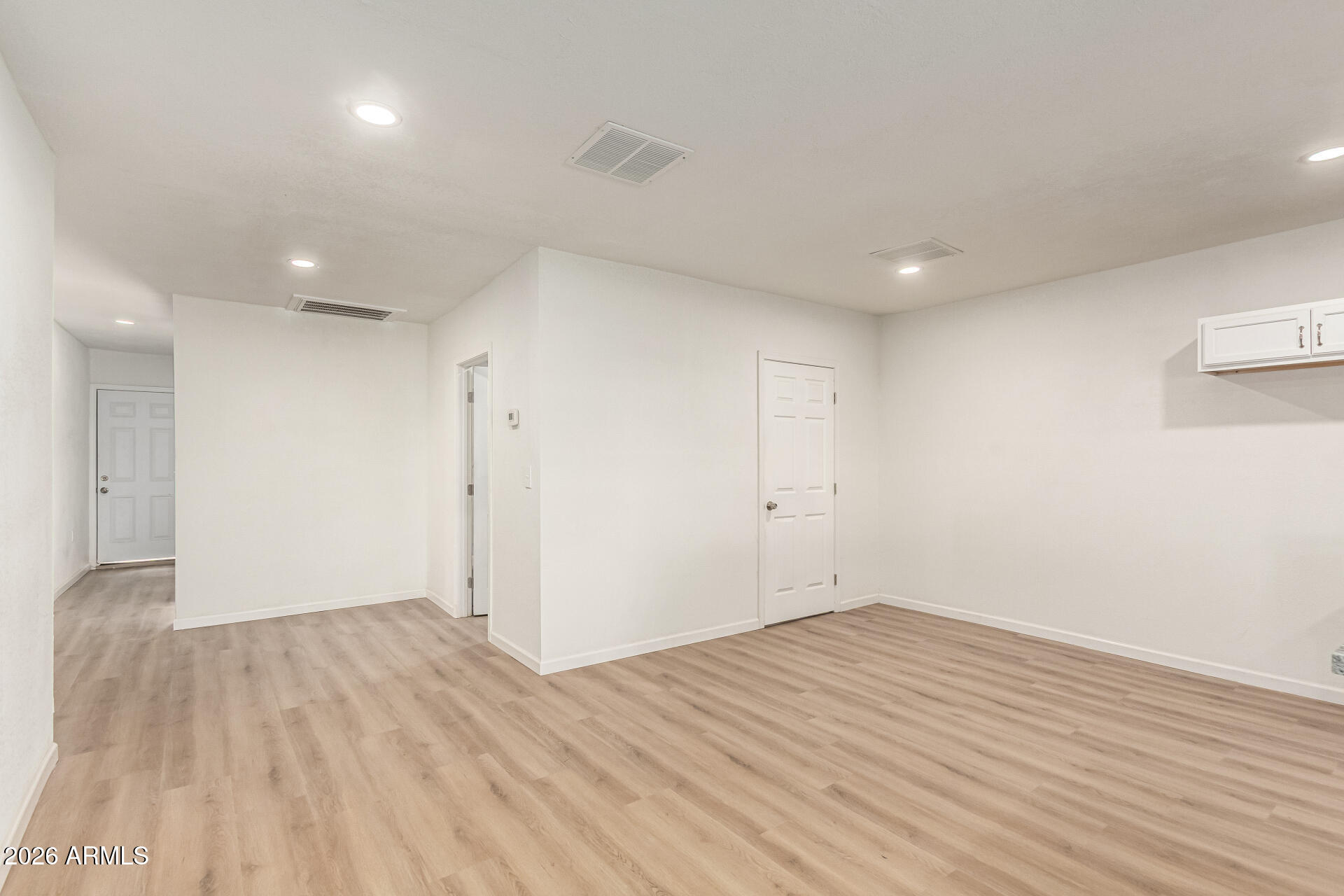 411 West Bealey Avenue Coolidge, AZ 85128 - Photo 8 of 26 an empty room with wooden floor