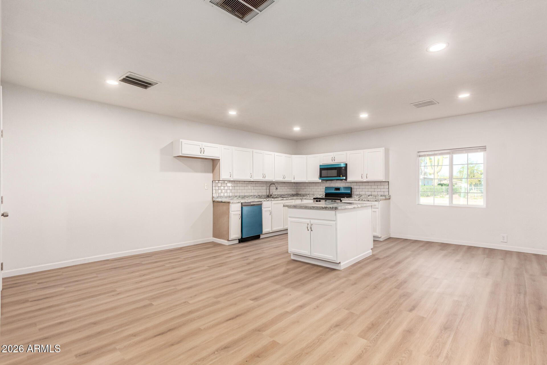 411 West Bealey Avenue Coolidge, AZ 85128 - Photo 9 of 26 a kitchen with granite countertop white cabinets and white appliances