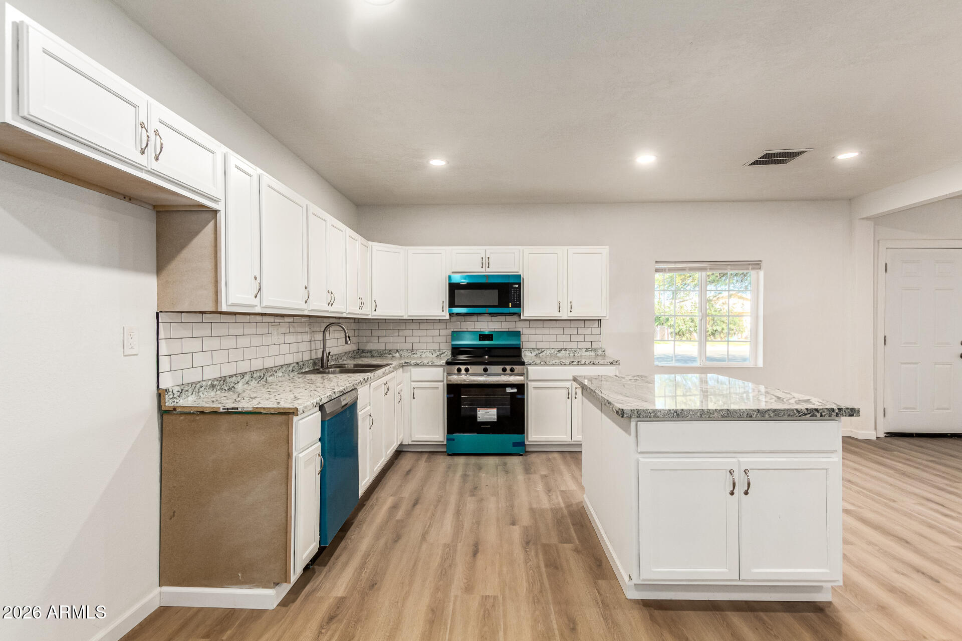 411 West Bealey Avenue Coolidge, AZ 85128 - Photo 10 of 26 a kitchen with stainless steel appliances granite countertop a stove sink and cabinets