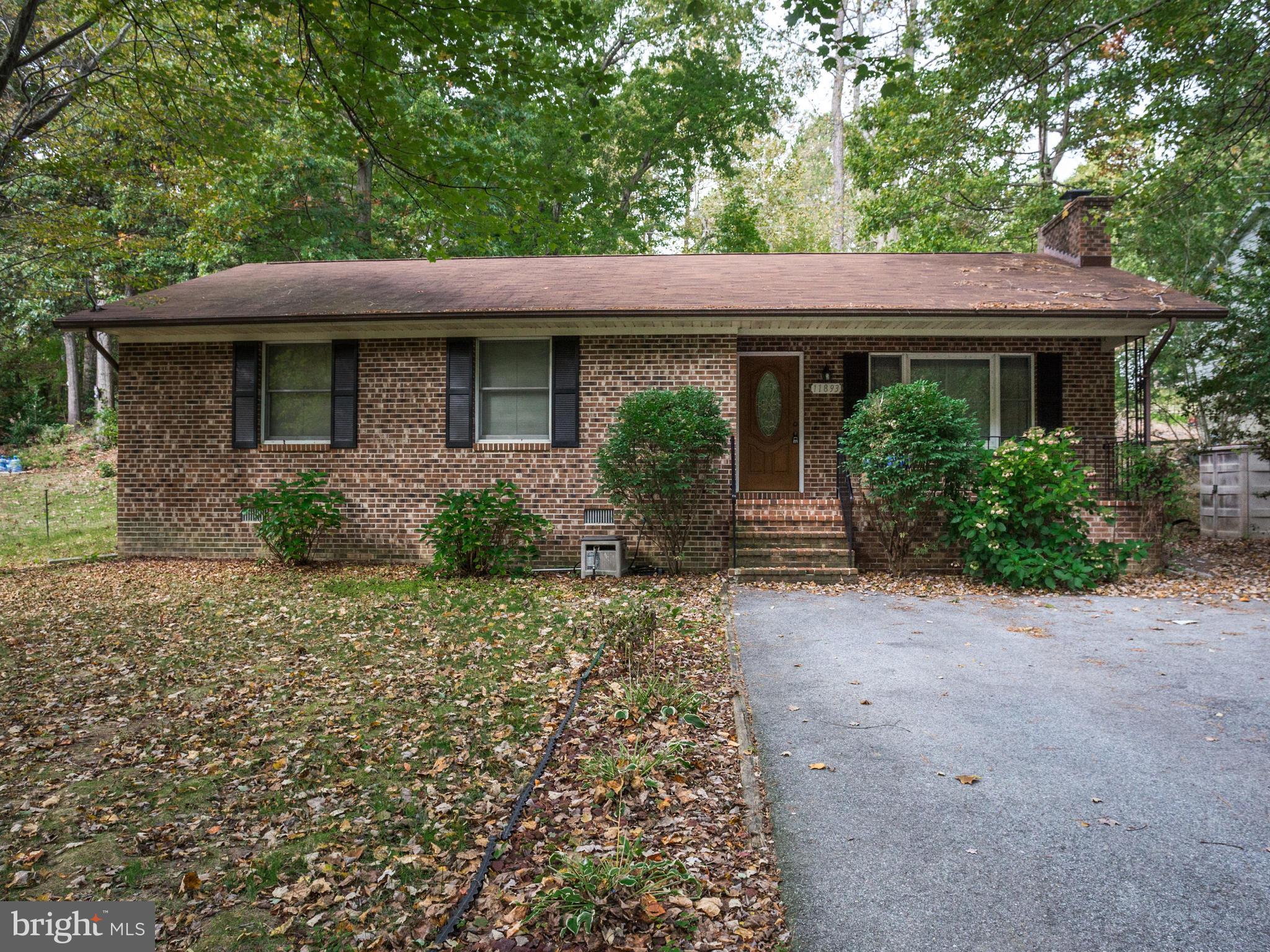 11893 Little Cove Point Road Lusby, MD 20657 - Photo 1 of 18 a front view of a house with garden