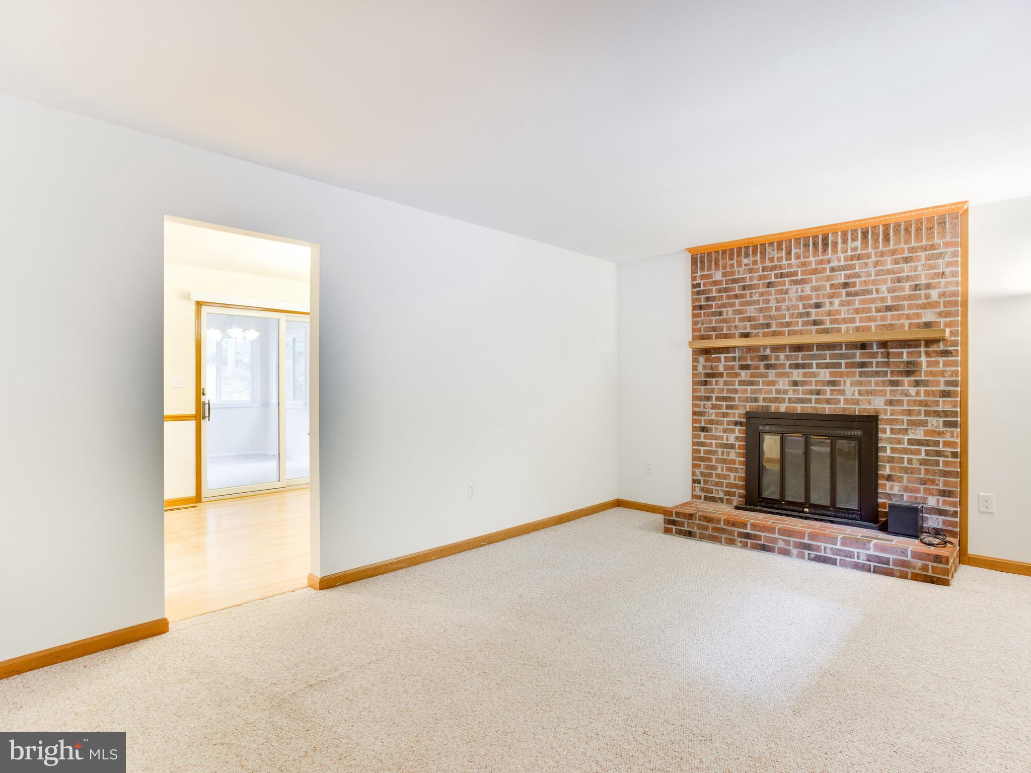 11893 Little Cove Point Road Lusby, MD 20657 - Photo 3 of 18 an empty room with a fireplace