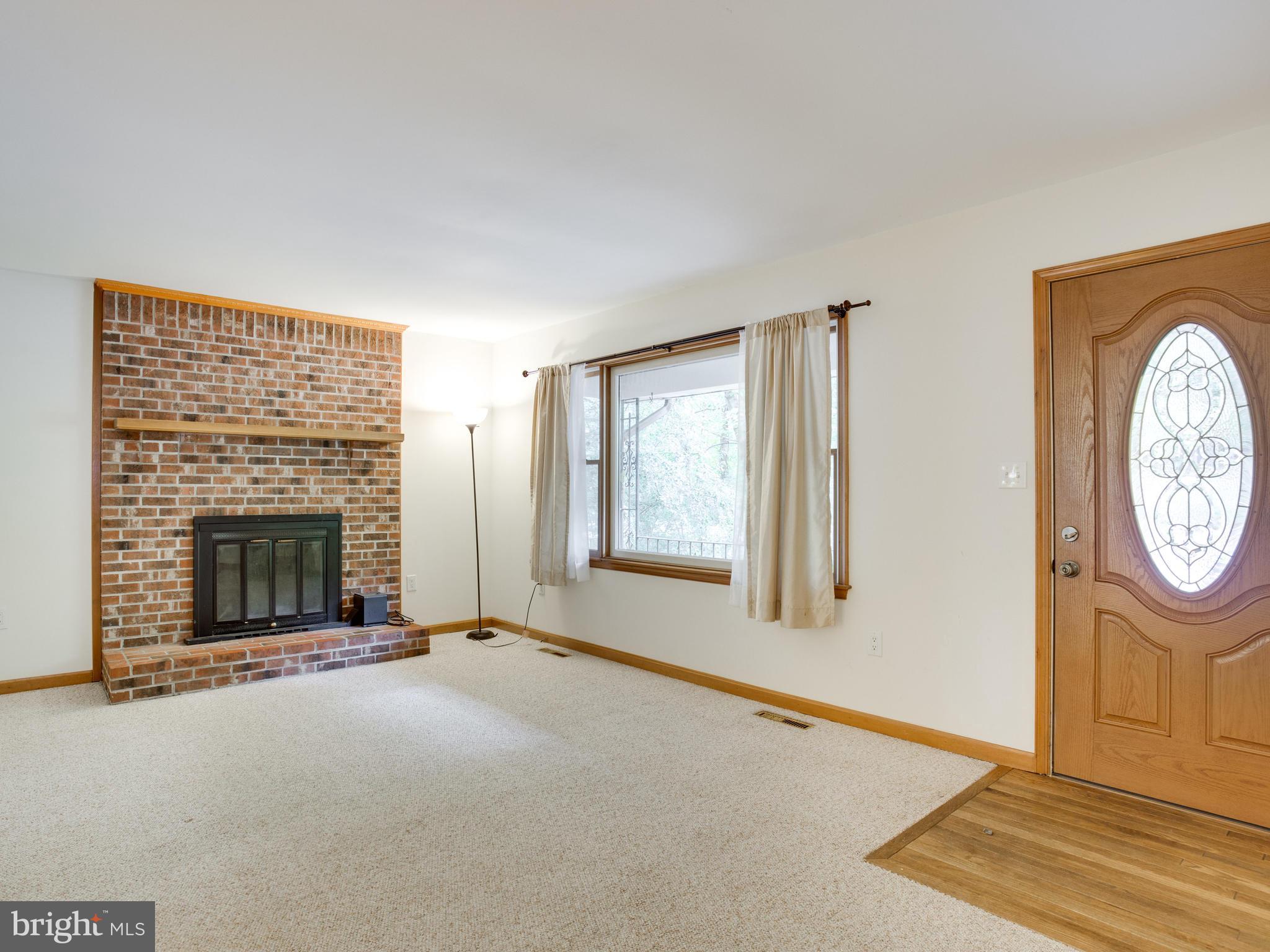 11893 Little Cove Point Road Lusby, MD 20657 - Photo 4 of 18 a view of an empty room with a fireplace
