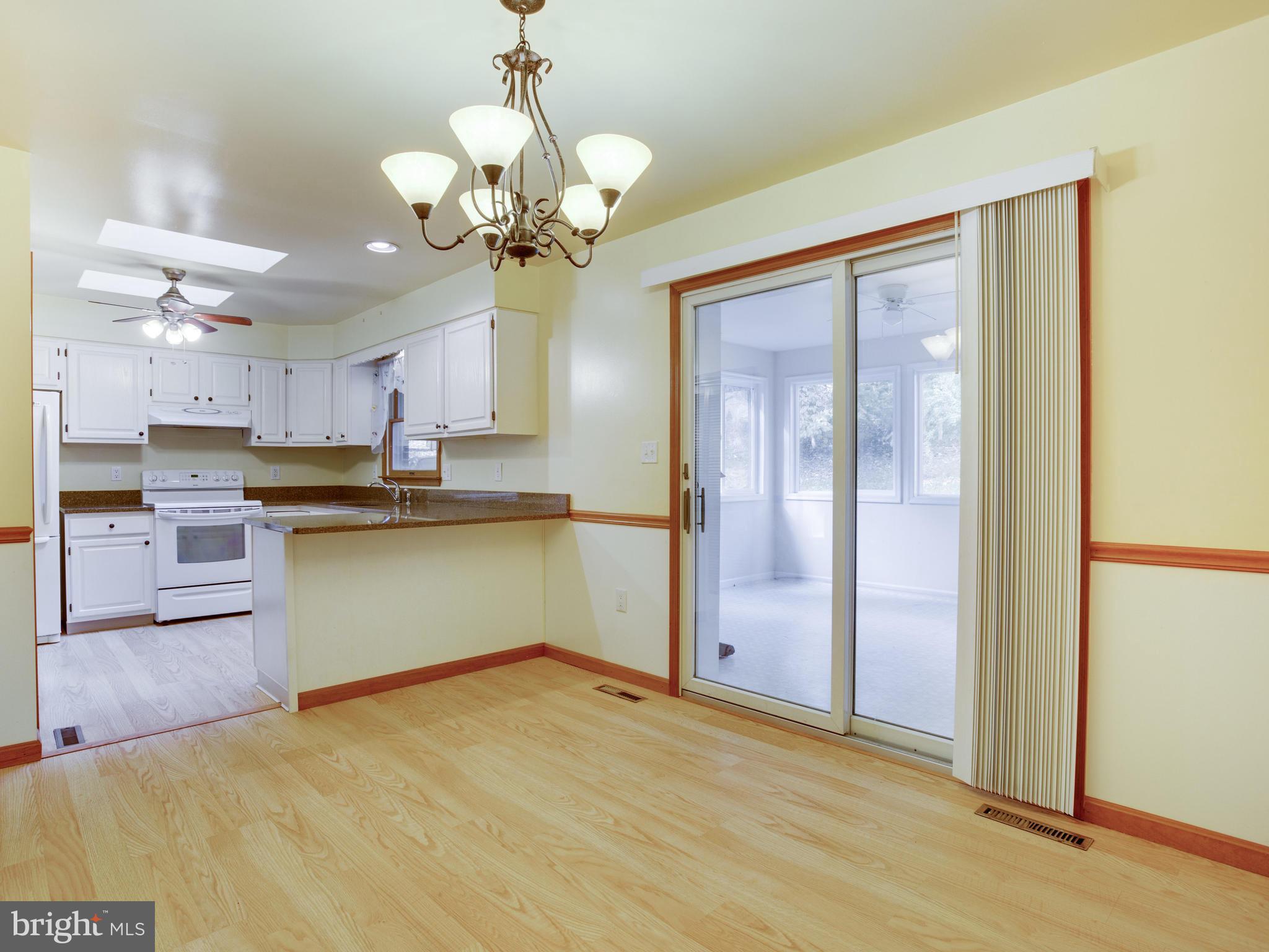 11893 Little Cove Point Road Lusby, MD 20657 - Photo 10 of 18 a view of a kitchen with a sink stainless steel appliances and cabinets