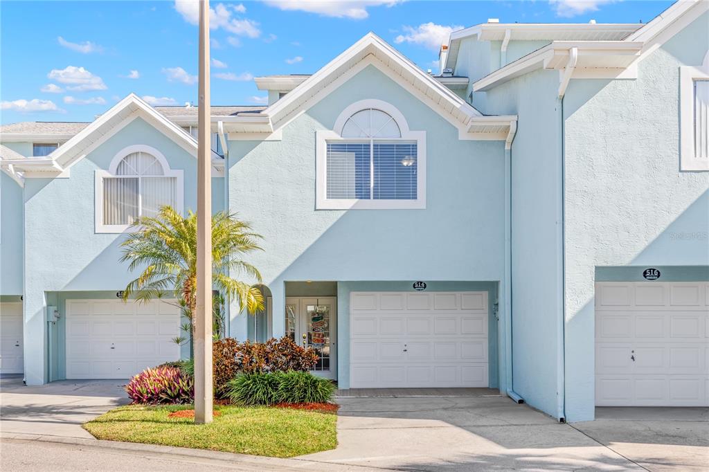 514 Garland Circle Indian Rocks Beach, FL 33785 - Photo 1 of 1 a front view of a house with a yard and garage