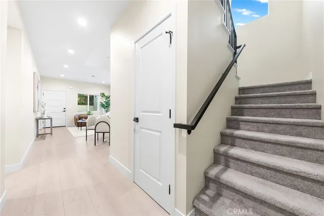 a view of a dining room with furniture and a potted plant