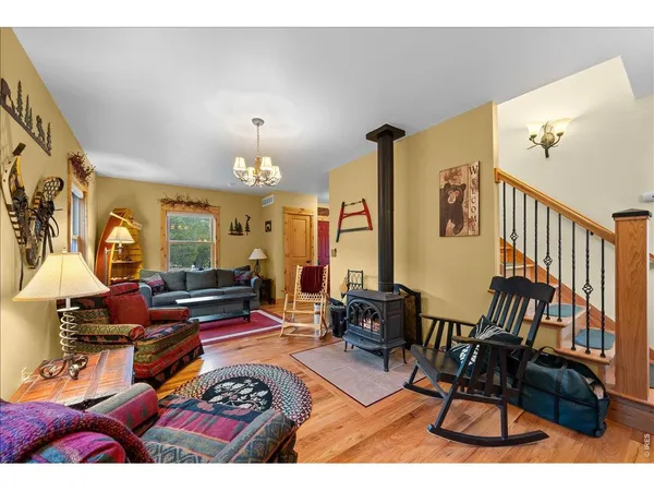 a living room with furniture a rug and a chandelier