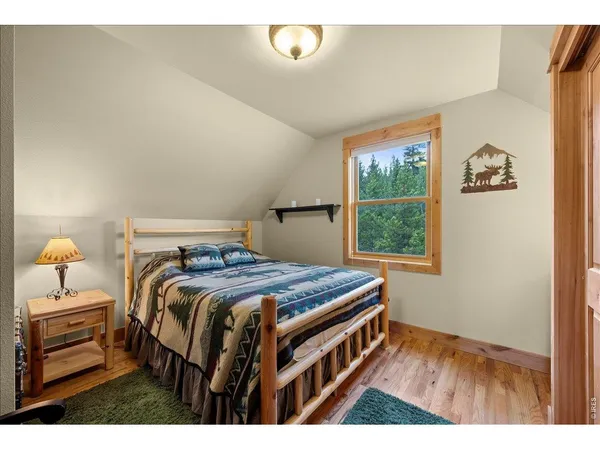 a bedroom with a bed next to a window