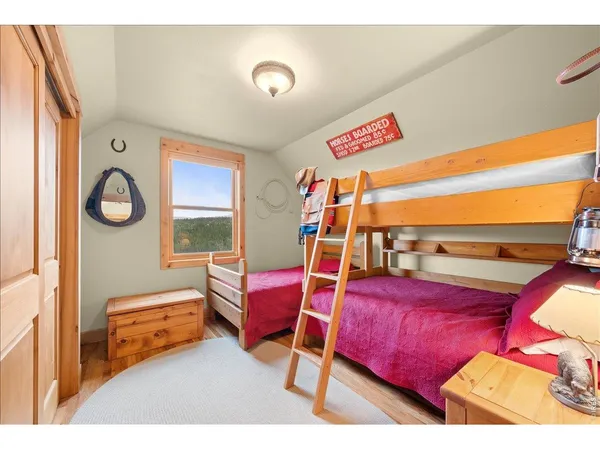 a bedroom with furniture and a wooden floor