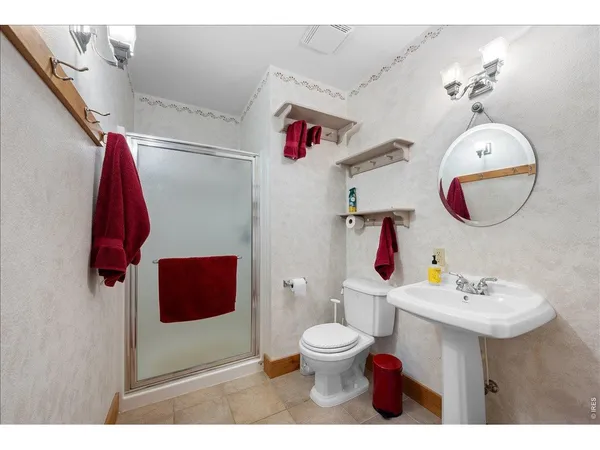 a bathroom with a sink mirror and toilet