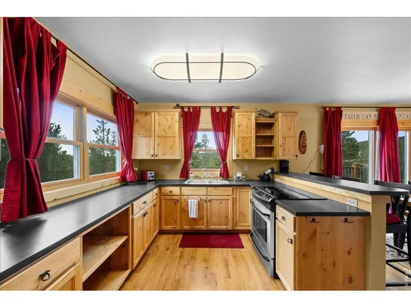 a kitchen with stainless steel appliances granite countertop a stove and a sink