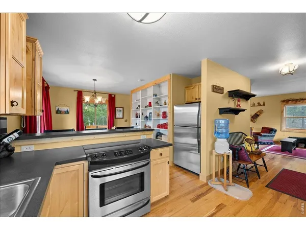 a kitchen with stainless steel appliances granite countertop a refrigerator and a stove top oven