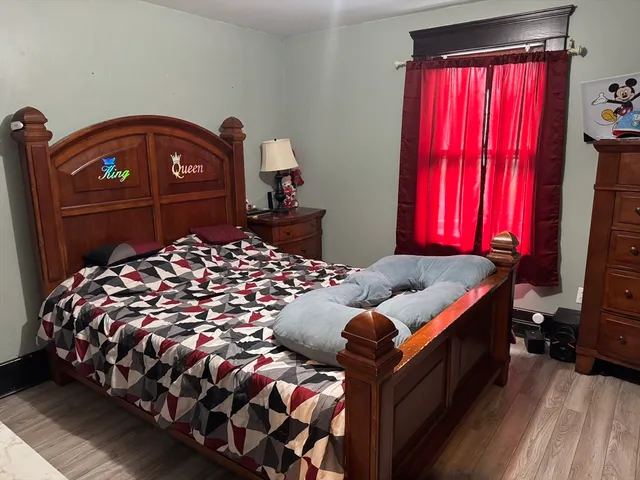 a bedroom with a bed and a window