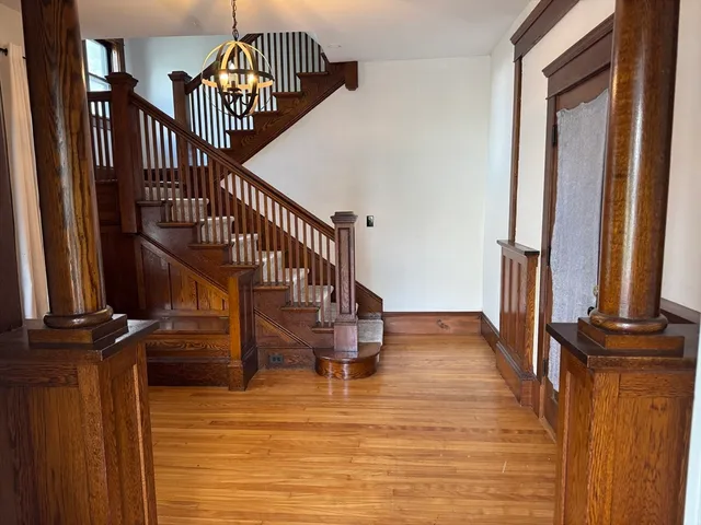 a view of entryway and hall with wooden floor
