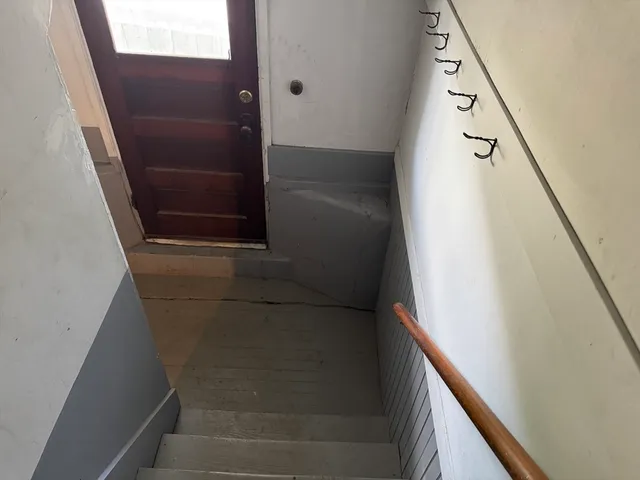 a view of staircase with white walls