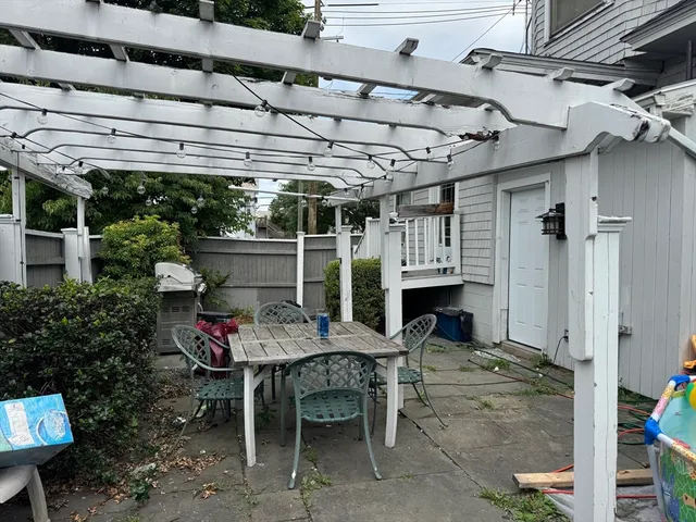 a backyard of a house with outdoor seating