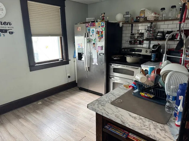 a view of a kitchen with fridge and rack