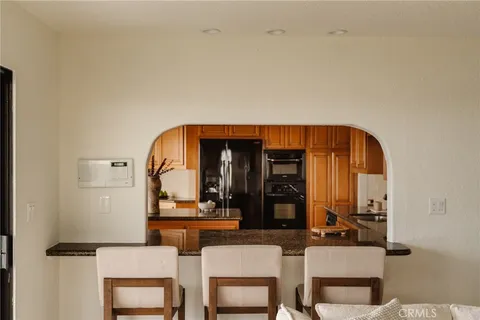a kitchen with granite countertop a sink stainless steel appliances and cabinets