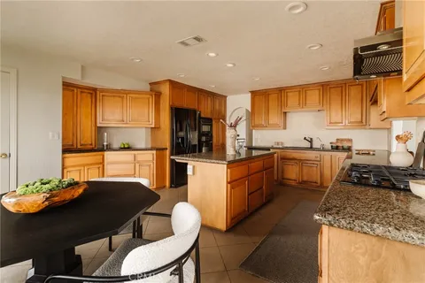 a kitchen with stainless steel appliances granite countertop a stove top oven a sink dishwasher and cabinets with wooden floor