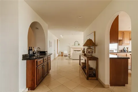 a dining room with furniture a chandelier and wooden floor