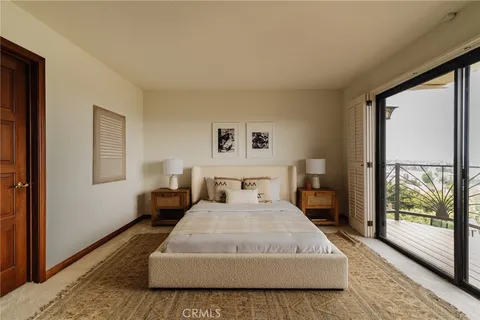 a bedroom with a large bed and a large window