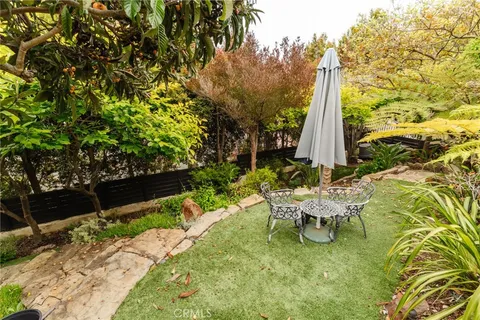 a view of a chair and table in backyard